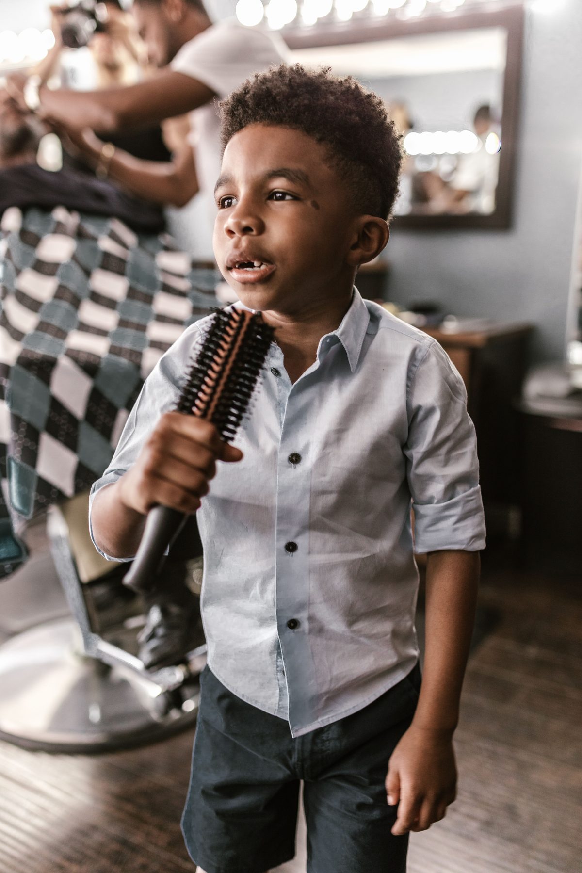 Playful brush portrait hairstyle shown on a boy under 12.