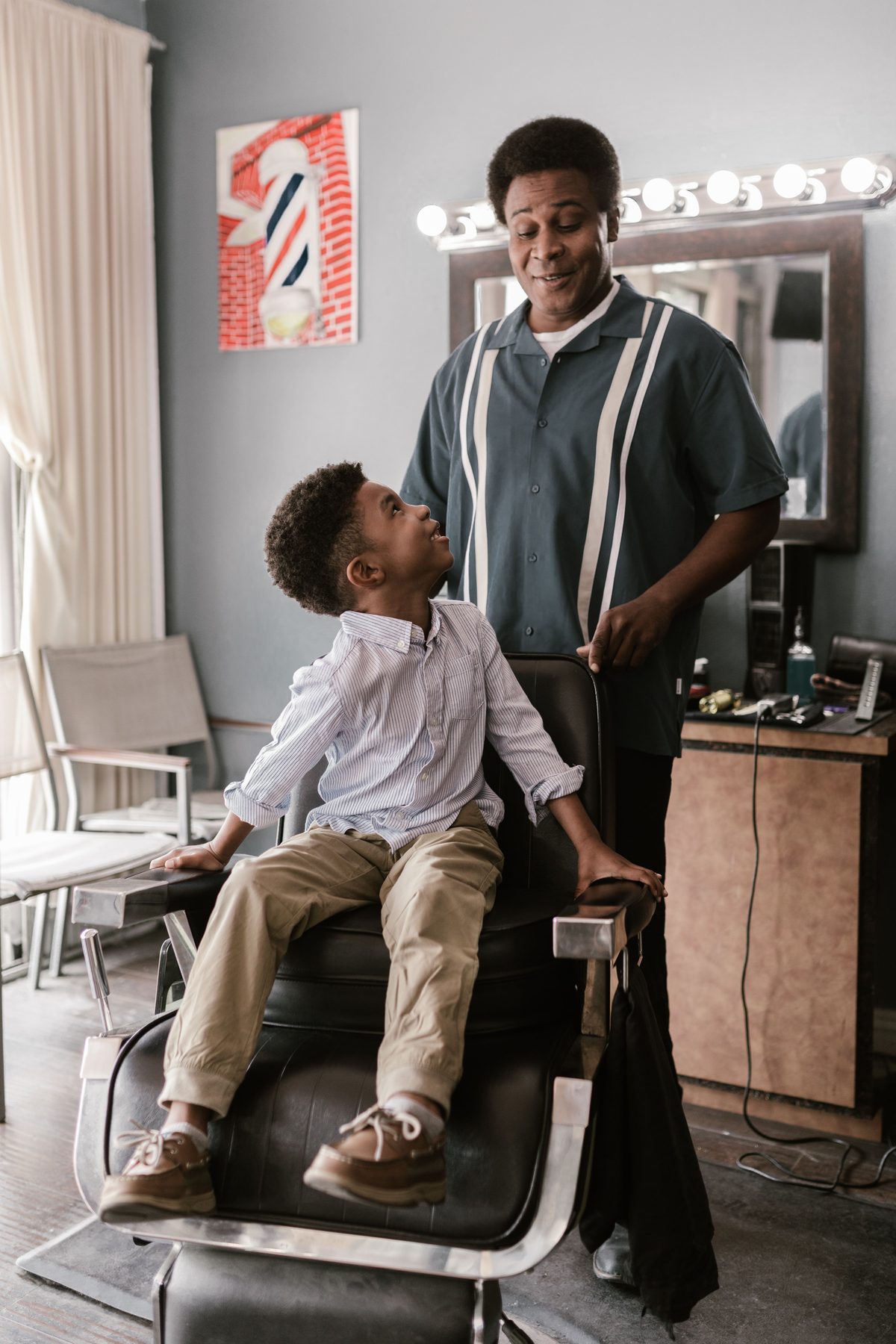 Father-son barbershop smile hairstyle shown on a boy under 12.