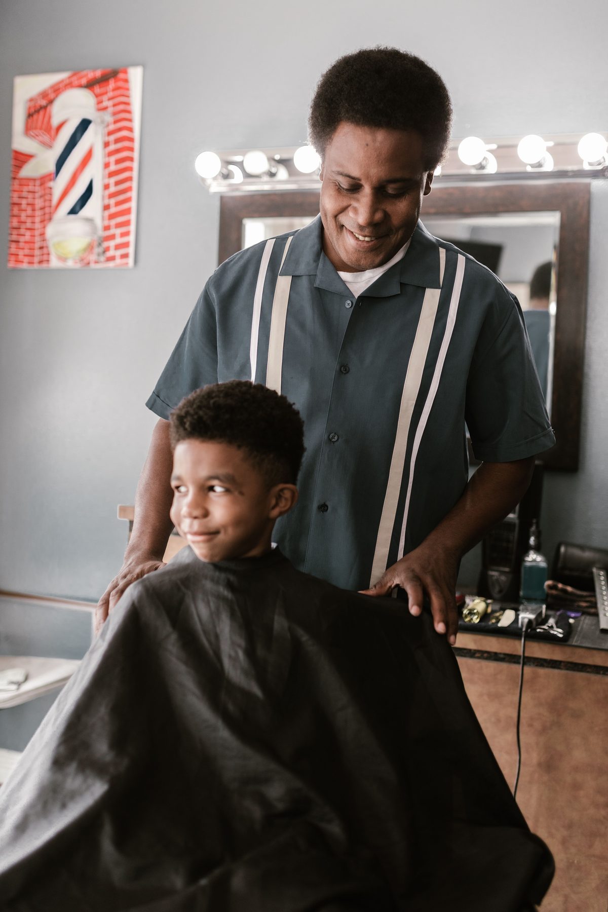Smiling pre-cut moment hairstyle shown on a boy under 12.