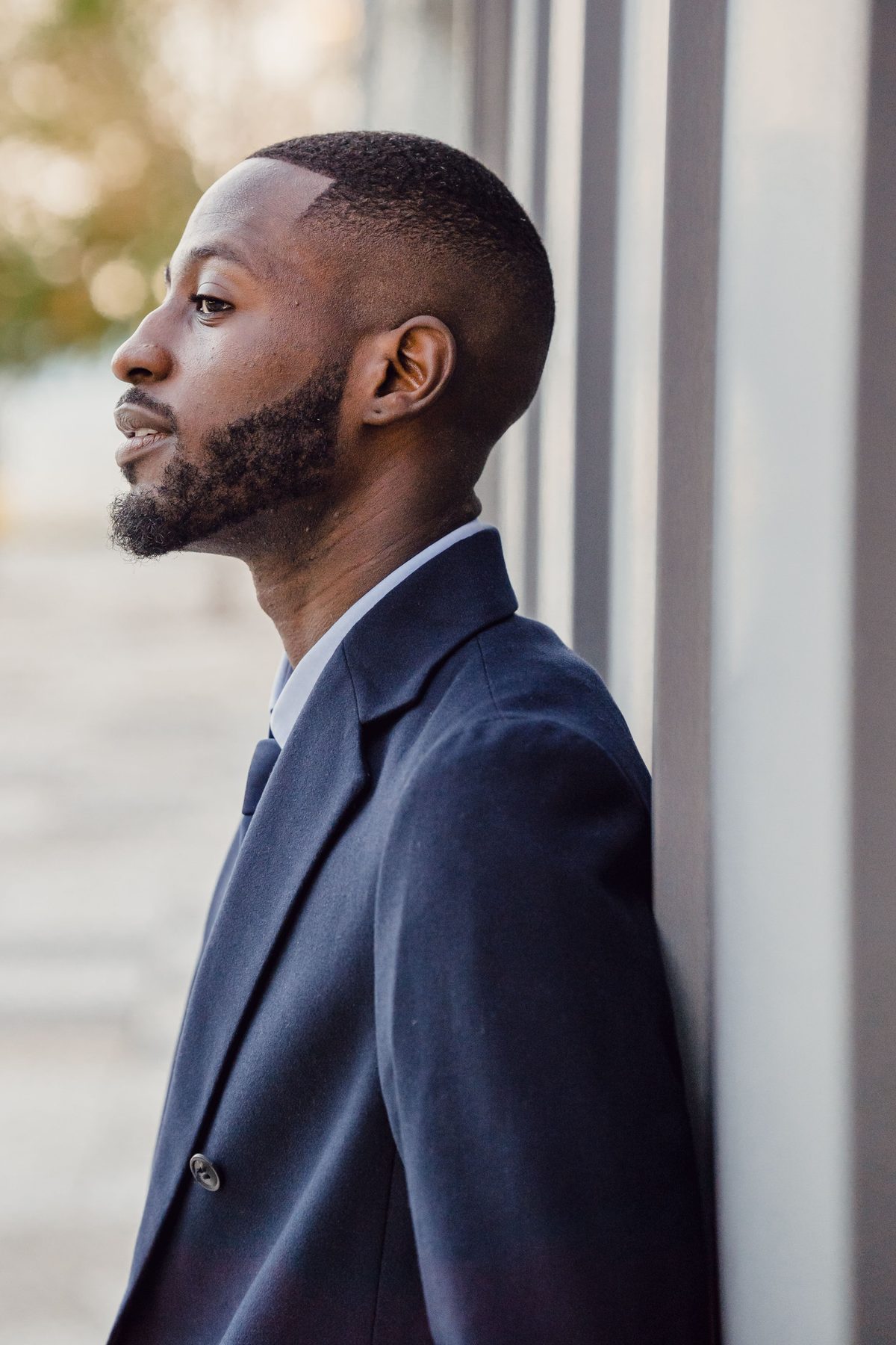 Outdoor suit profile hairstyle shown on a professional man.