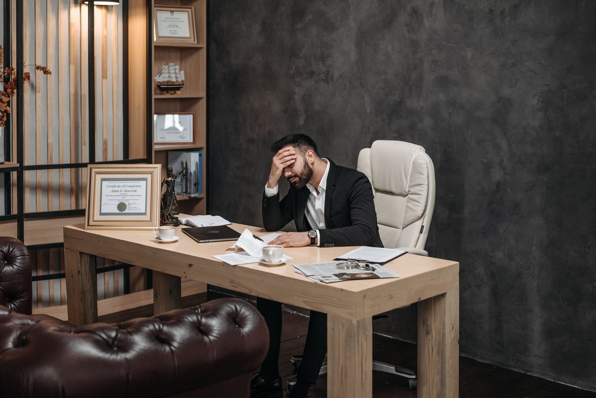Office suit contemplation hairstyle shown on a professional man.