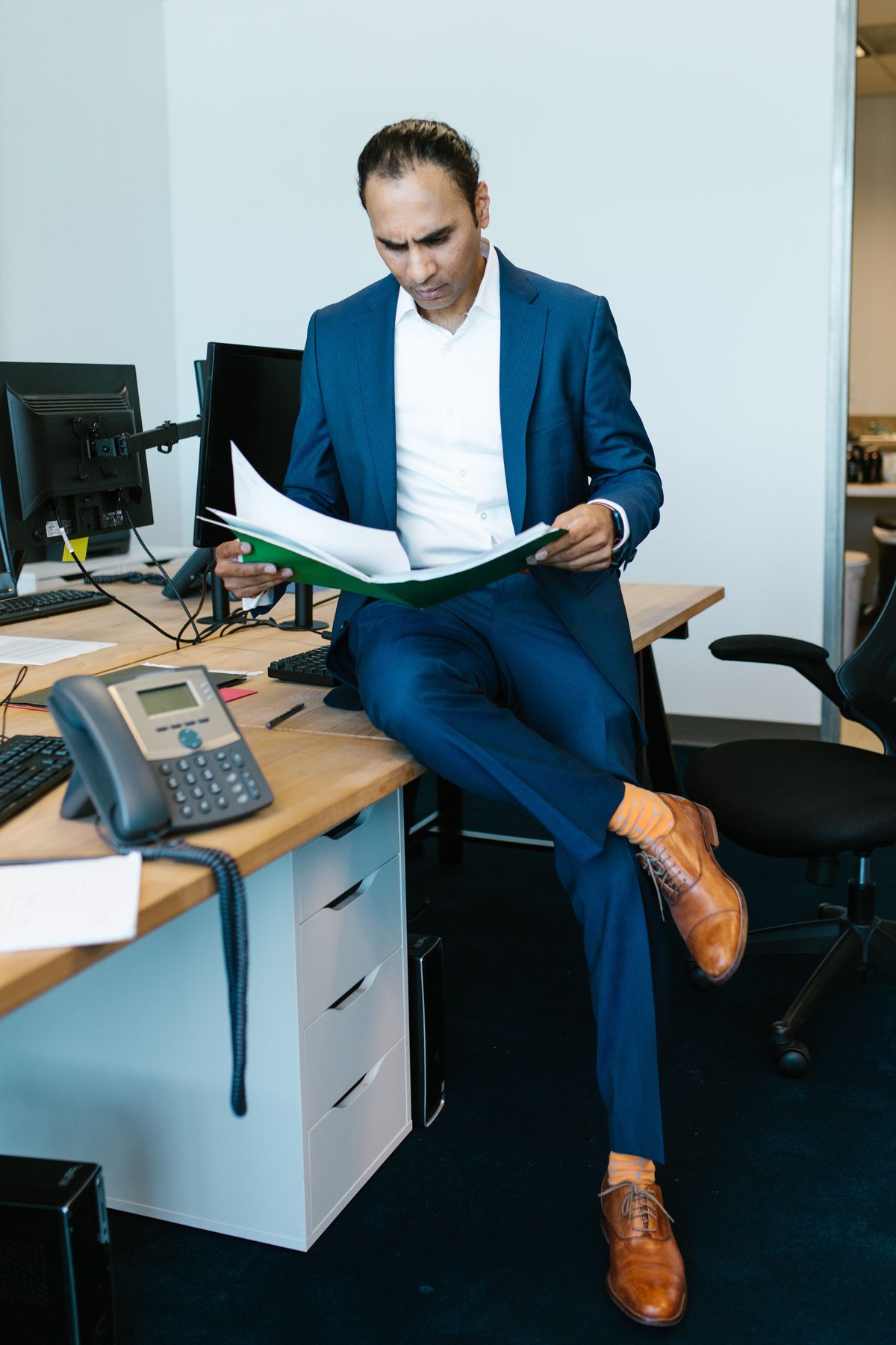 Blue suit documents hairstyle shown on a professional man.