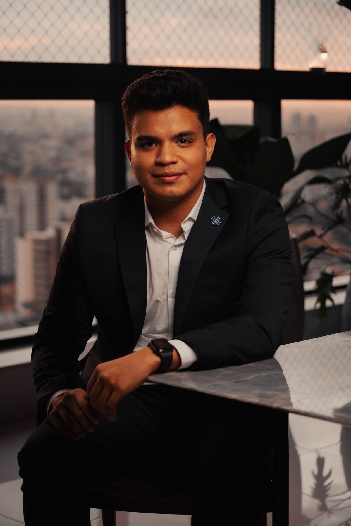 Seated black suit hairstyle shown on a professional man.