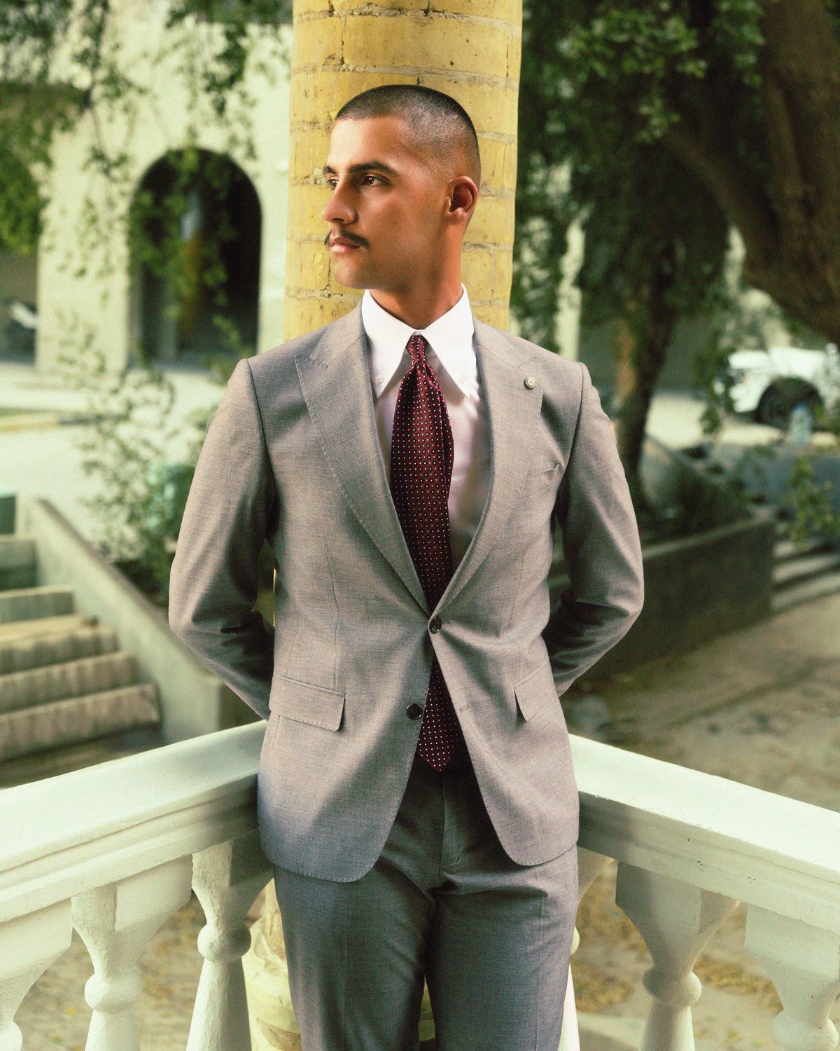 Grey suit red tie hairstyle shown on a professional man.