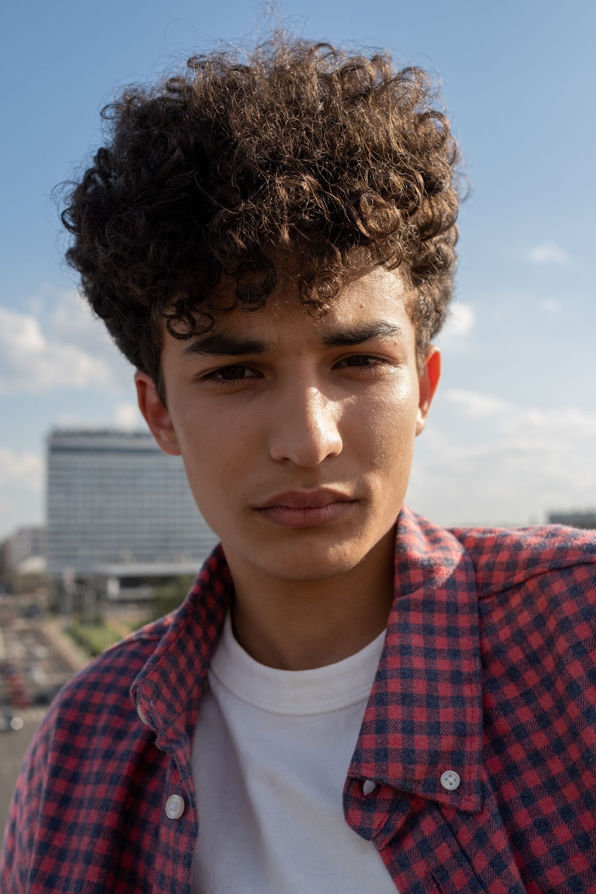 Curly teen portrait hairstyle shown on a teenager.