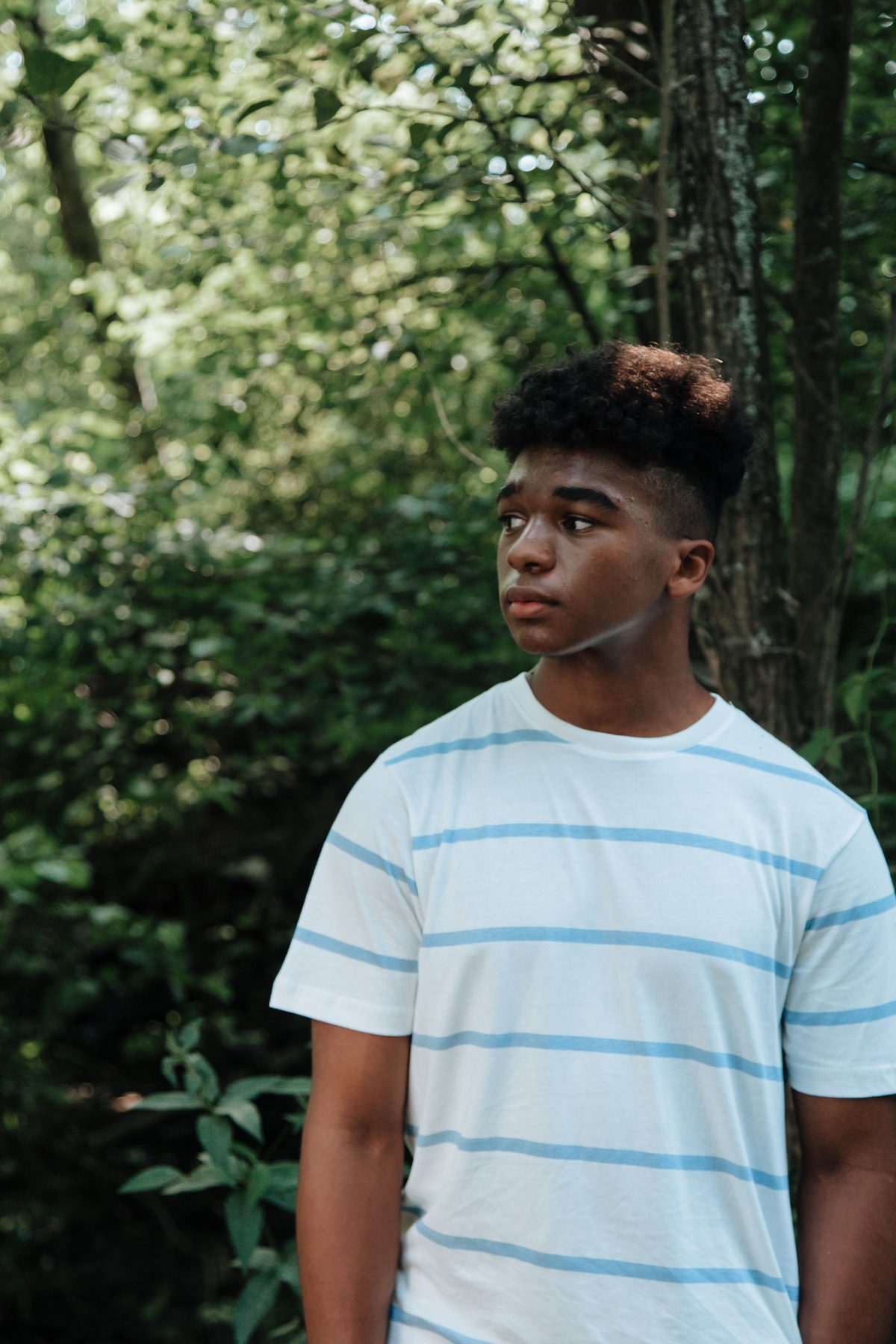 Striped-shirt forest teen hairstyle shown on a teenager.
