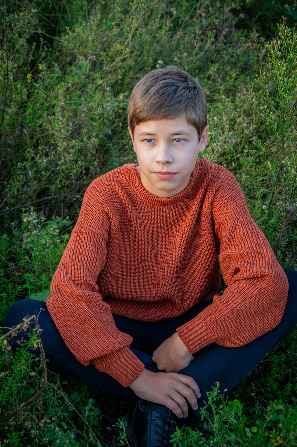 Orange sweater nature teen hairstyle shown on a teenager.