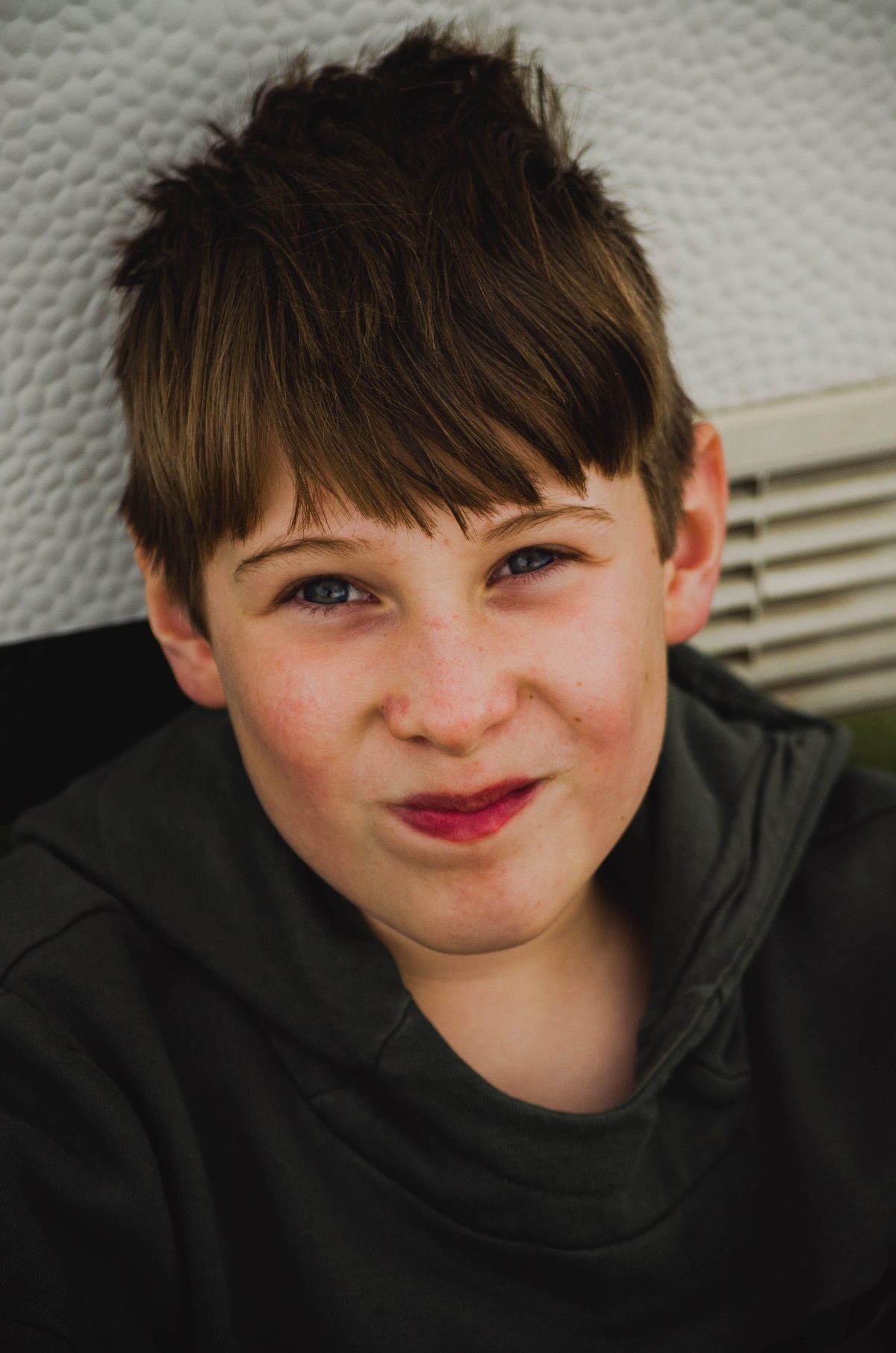 Smiling tween portrait hairstyle shown on a teenager.