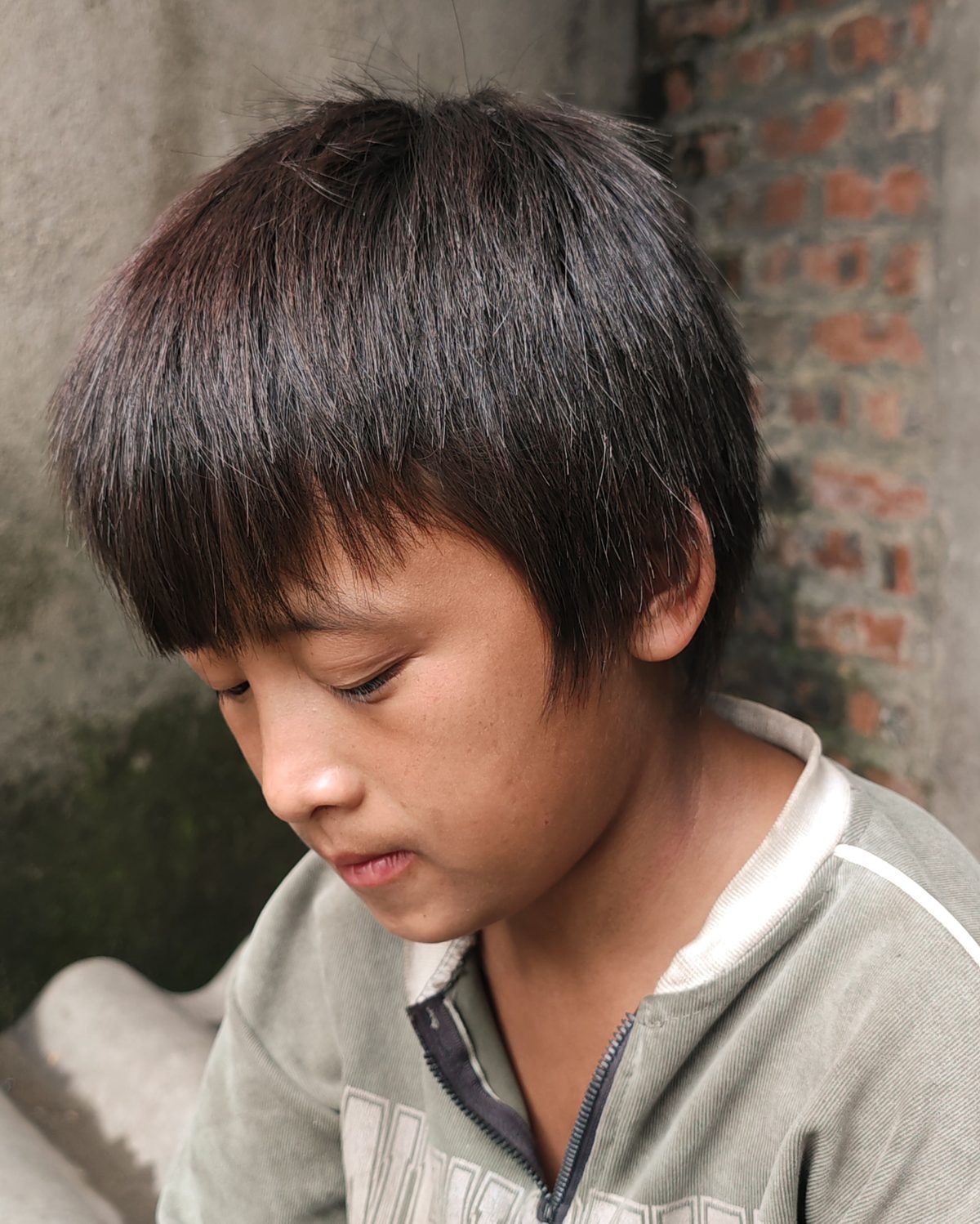 Pensive casual teen hairstyle shown on a teenager.