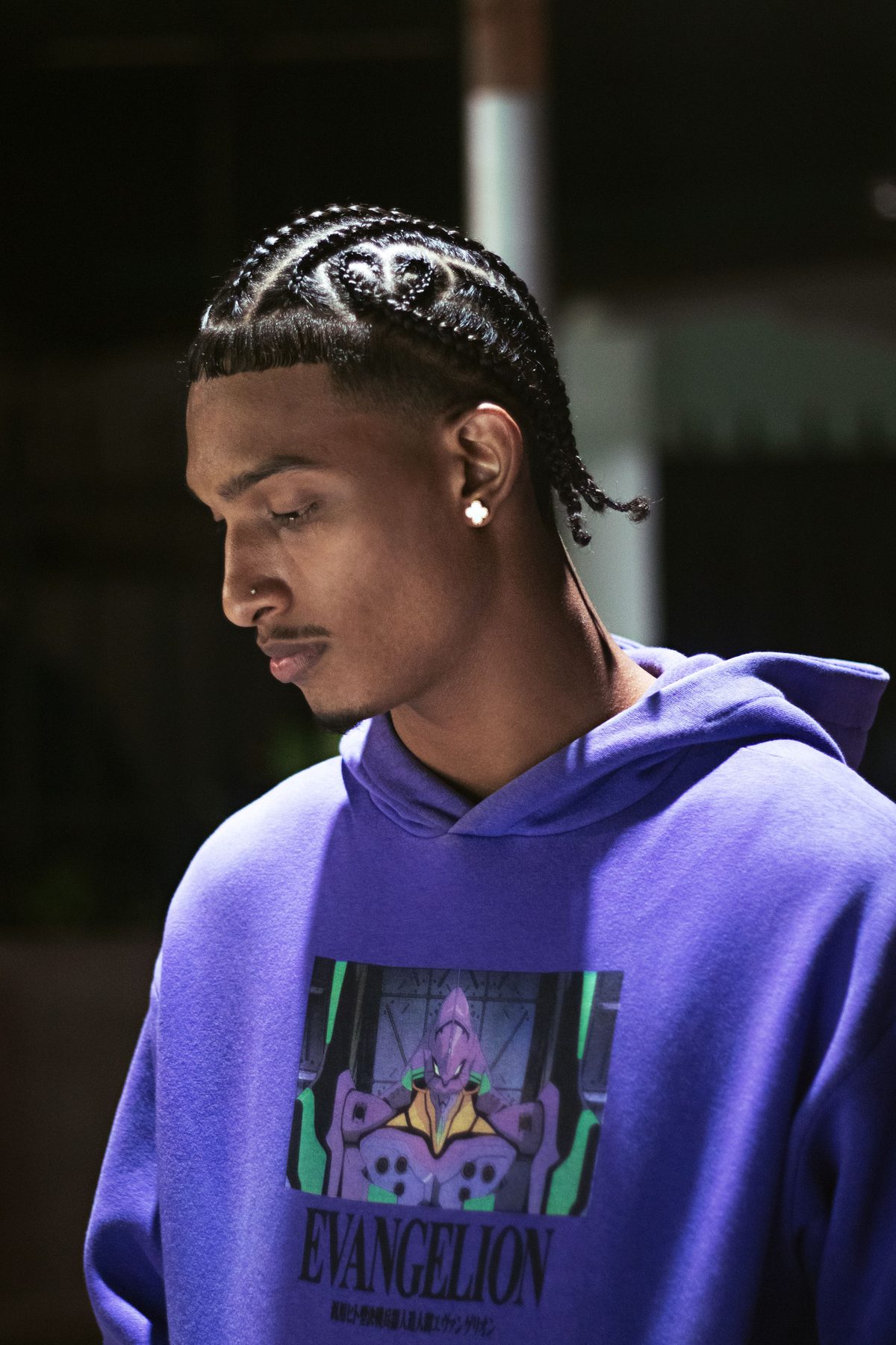 Braided urban profile hairstyle shown on a young man.