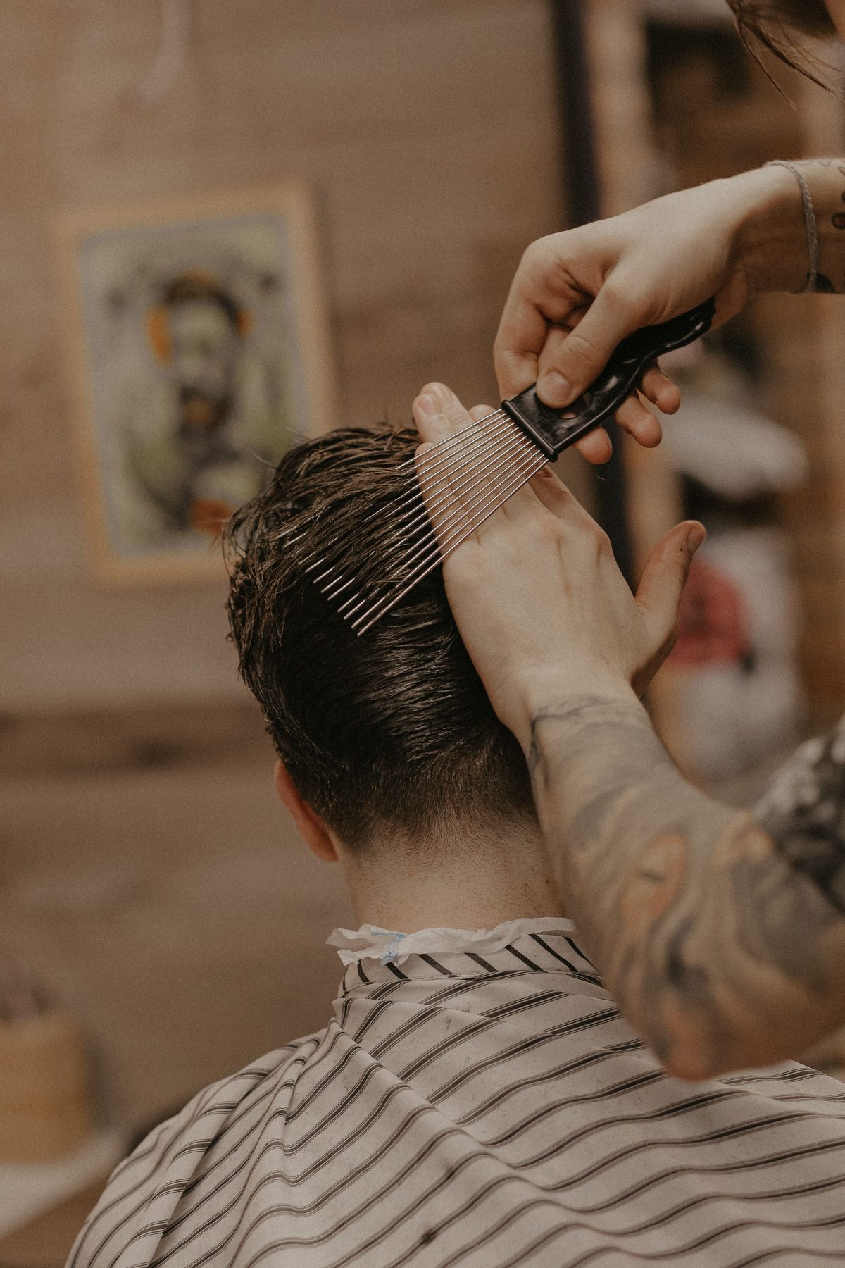 Rustic barbershop cut hairstyle shown on a young man.