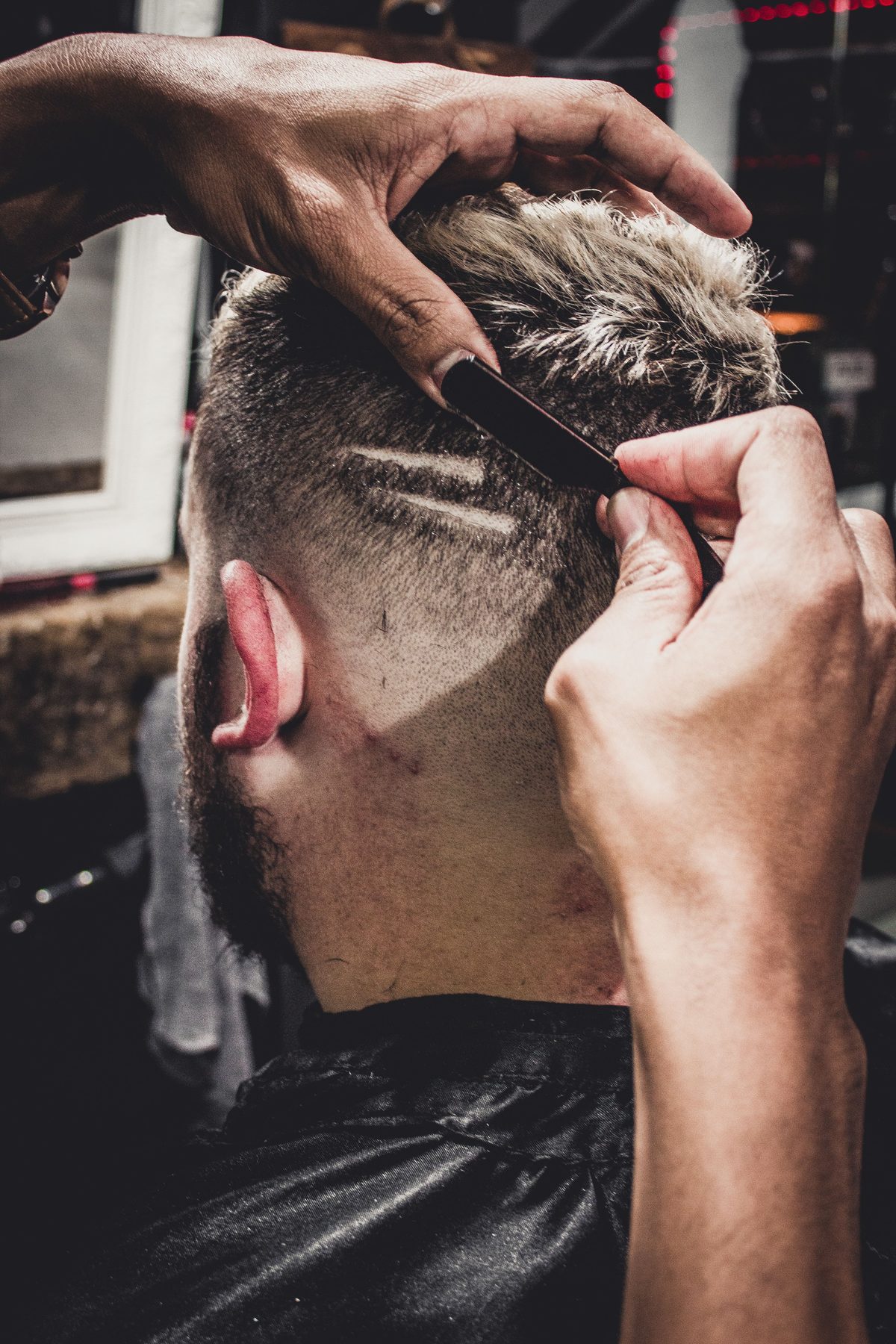Straight razor detail hairstyle shown on a young man.