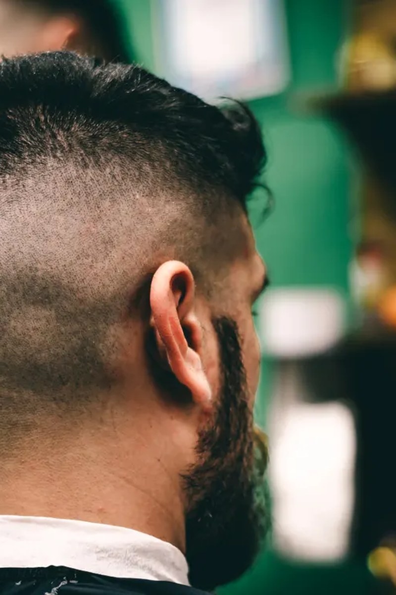 Close rear view of a sharp low fade showing a clean curved blend