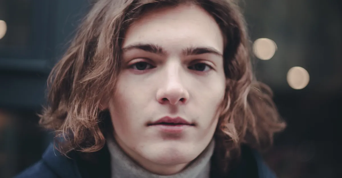Young man with a neatly shaped medium-length hairstyle