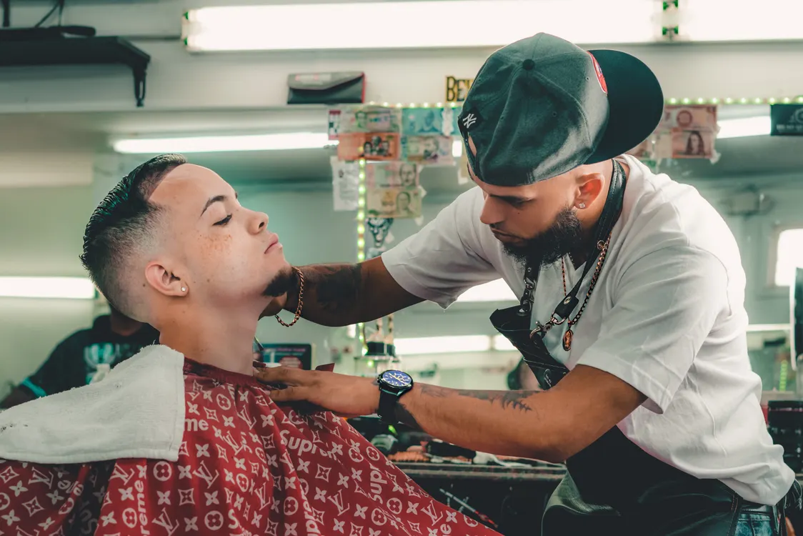 Low fade haircut being shaped with clippers