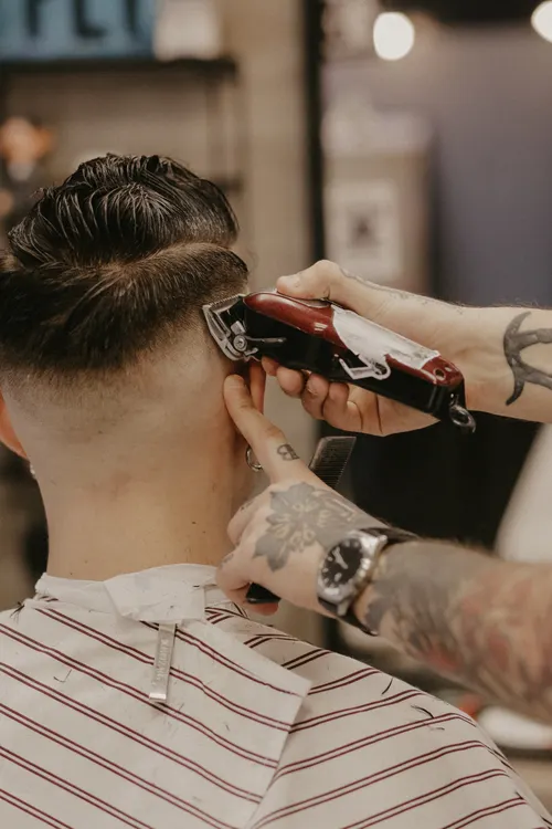 Barber refining a short taper haircut