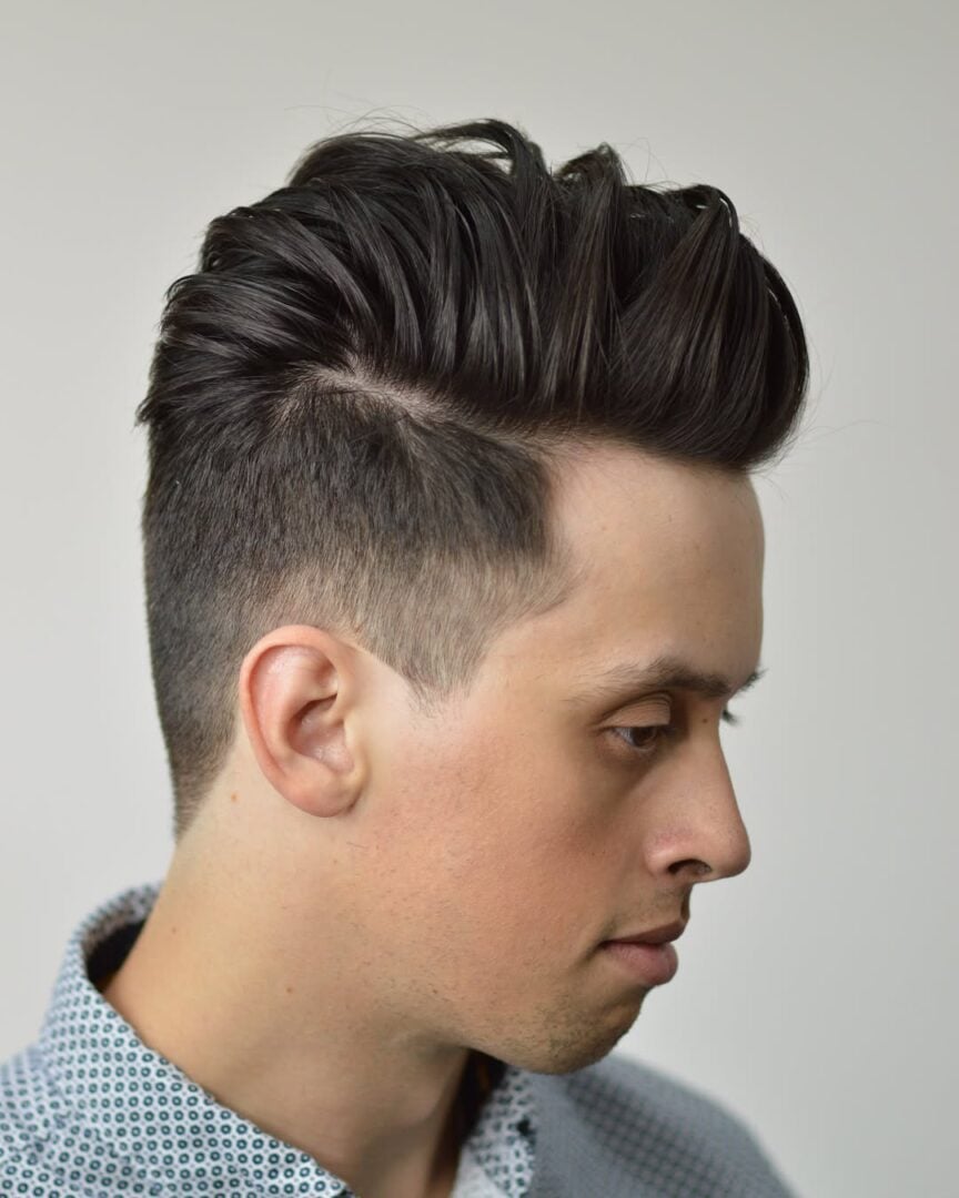 Straight-hair blowout taper, volume swept up with a tapered side, side view