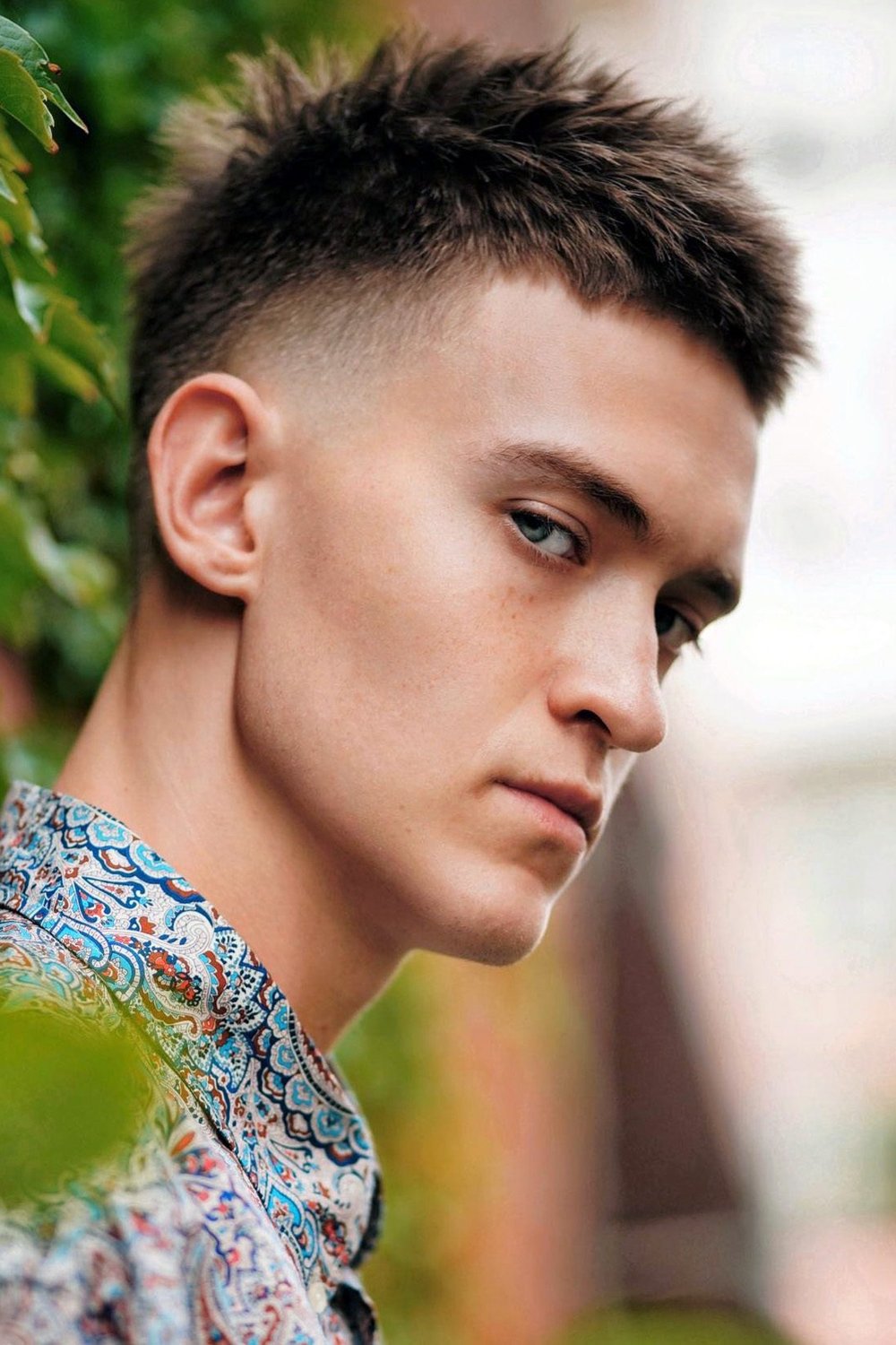 High taper fade with a choppy textured crop on top, sharp fade starting at the temples