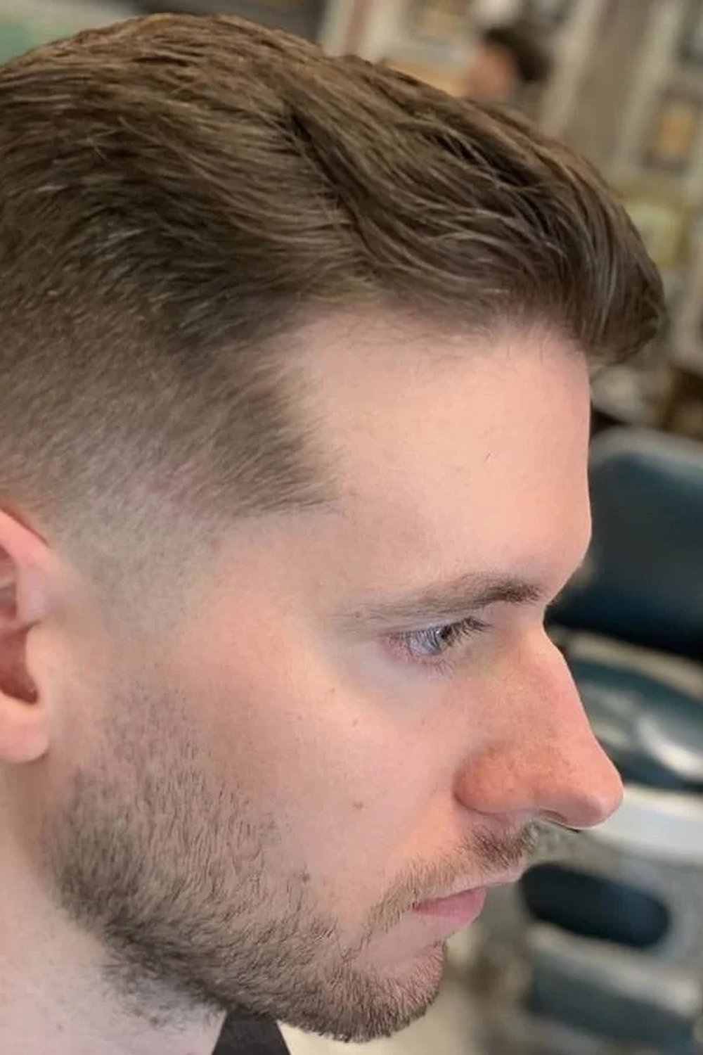 Man with a low skin fade and a neat flat textured top