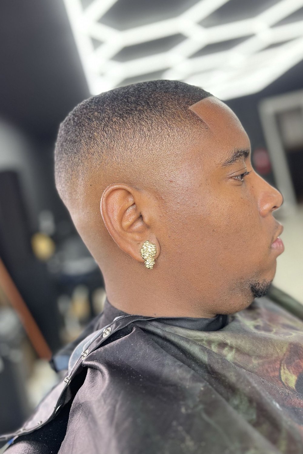 Side profile of an executive buzz fade with faded sides and a sharp lineup