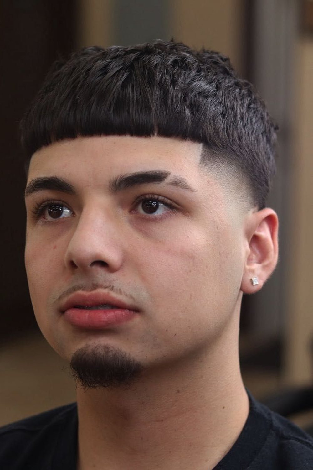 Edgar haircut with a crisp line-up at the forehead and temples
