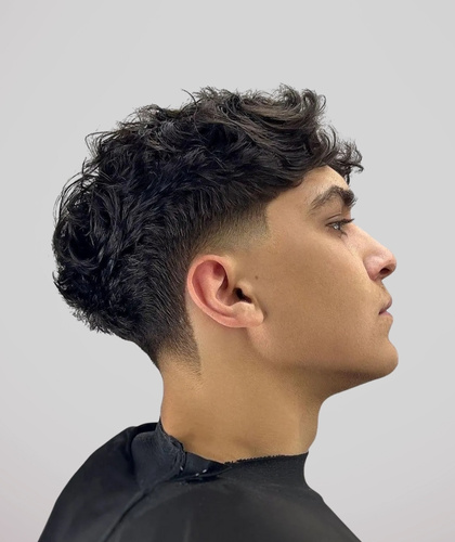 Curly top with a mid taper fade