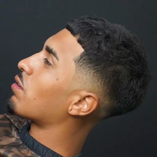 Wavy Burst Fade haircut reference showing the low-profile arc