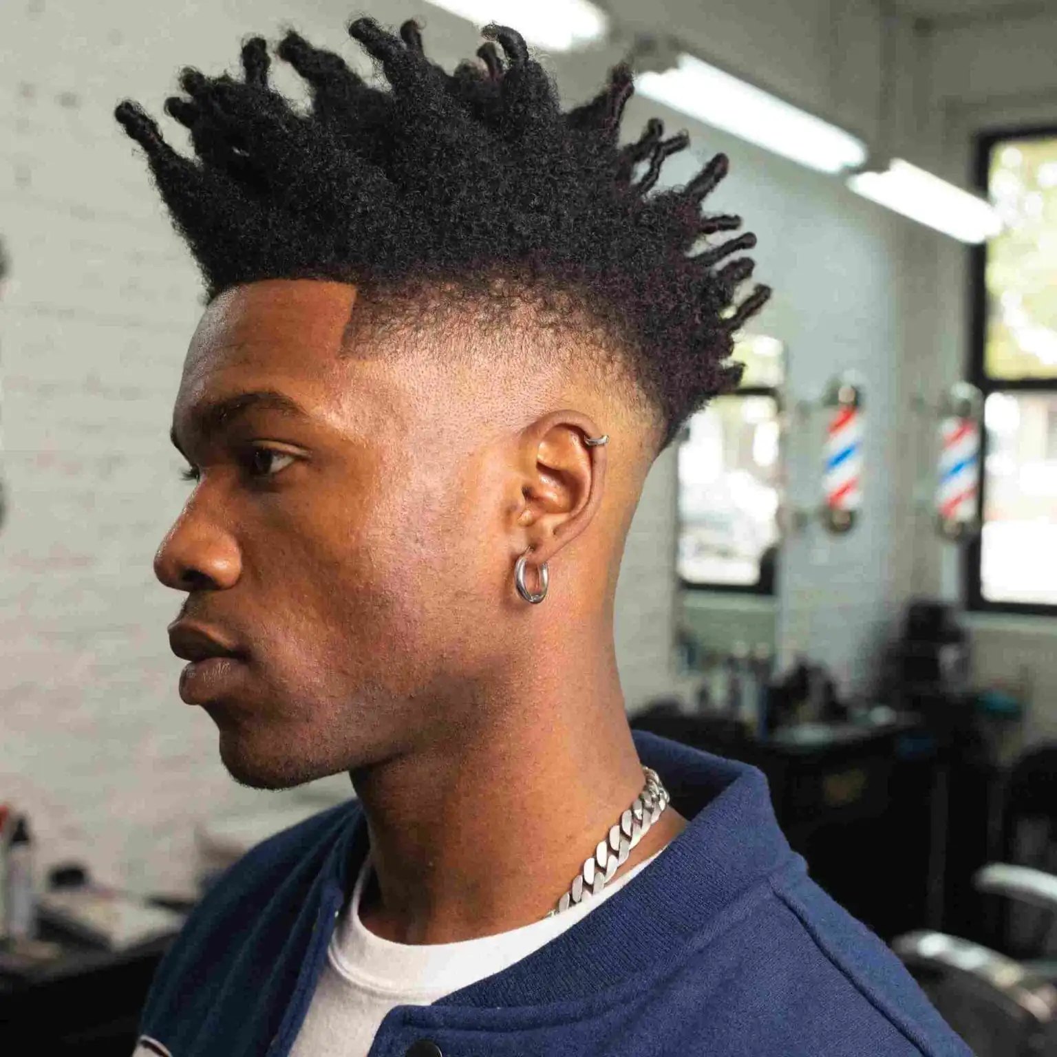 Curly Burst Fade haircut reference showing the high-contrast version