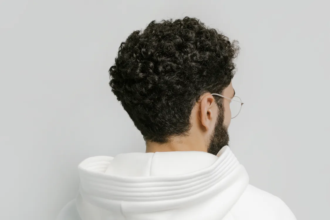 Back view of a man with short curly hair