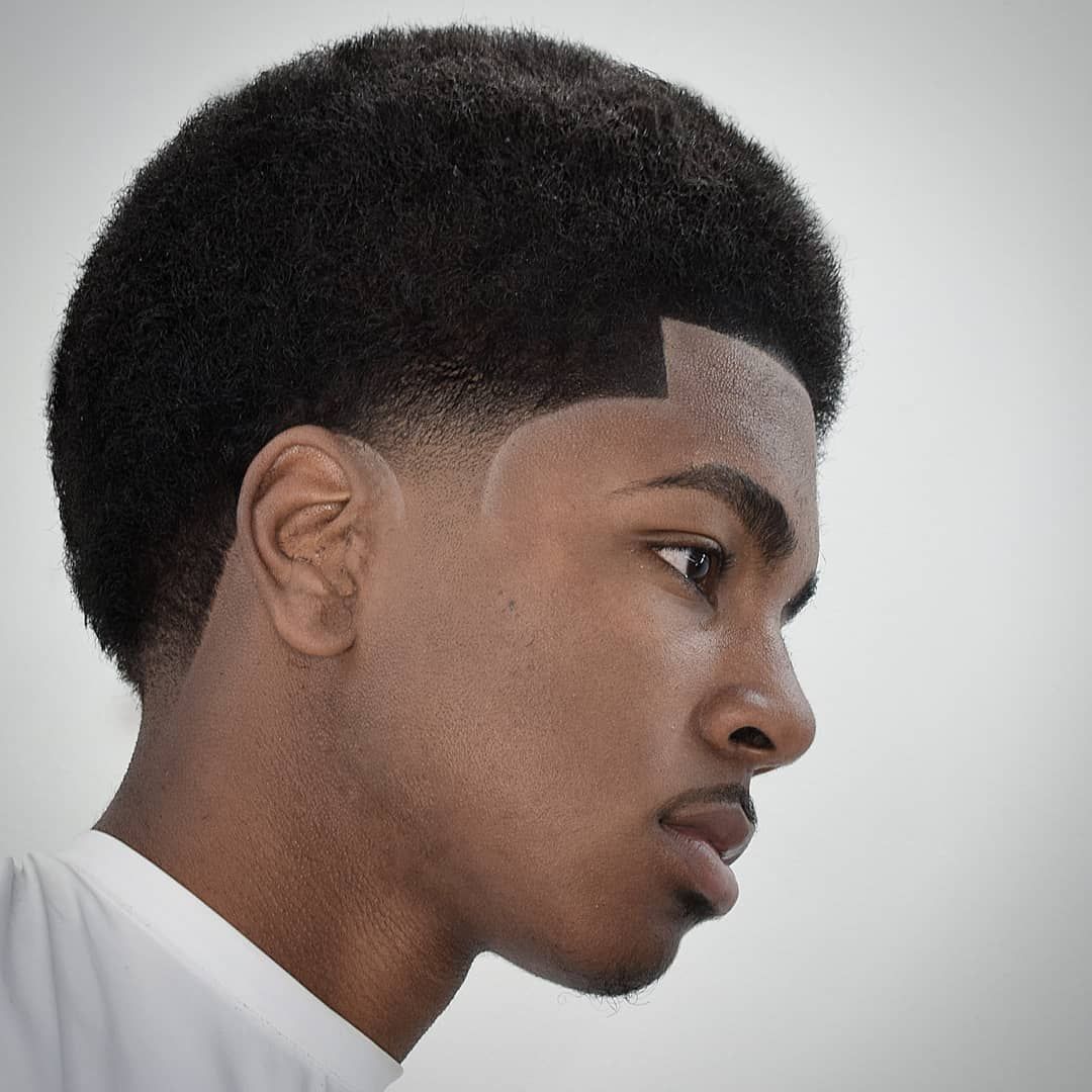 Short fade with temple detailing on straight hair.